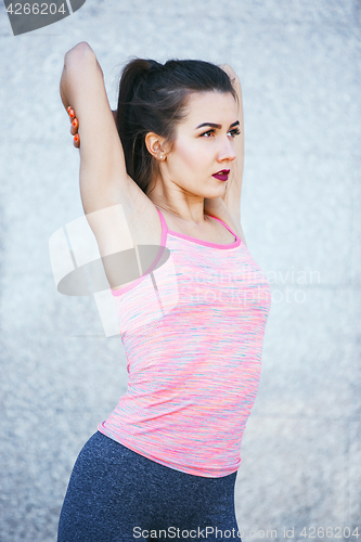 Image of Fit fitness woman doing stretching exercises outdoors at park