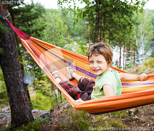 Image of little cute boy in hammock smiling