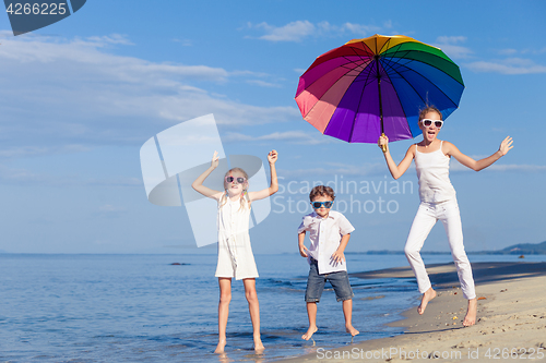Image of Happy children playing on the beach at the day time.