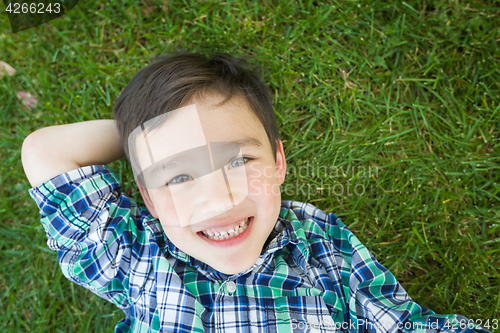 Image of Mixed Race Chinese and Caucasian Young Boy Relaxing On His Back 