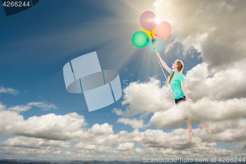 Image of Young Adult Female Being Carried Up and Away Into The Clouds By 