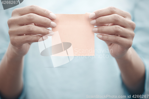 Image of Woman holding adhesive note