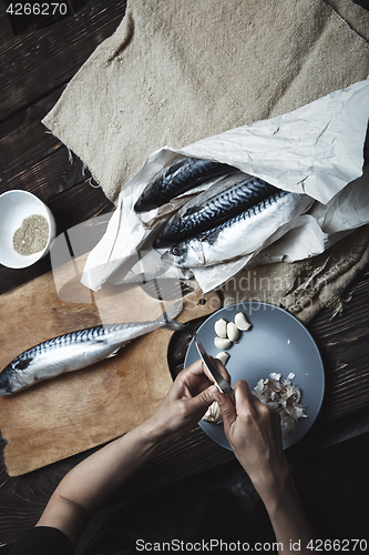 Image of Woman preparing fish