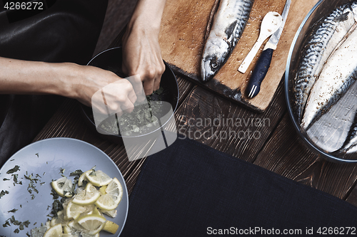 Image of Woman preparing marinade for fish