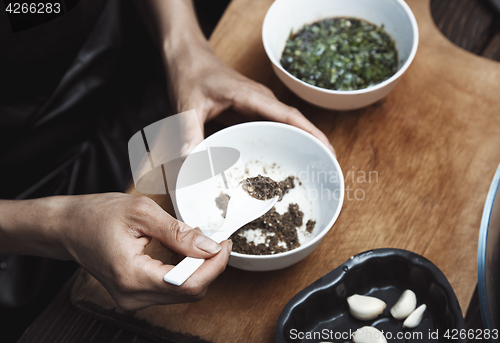 Image of Woman preparing Indian sauce for vegetarian food