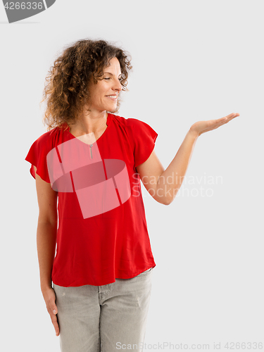 Image of Happy woman showing something