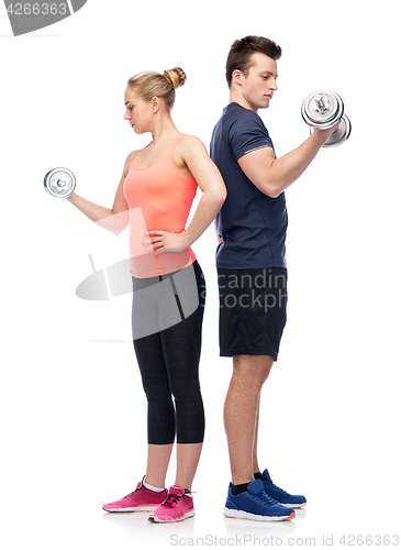 Image of sportive man and woman with dumbbells