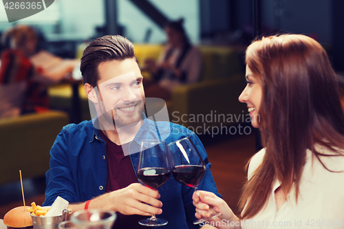 Image of couple dining and drinking wine at restaurant