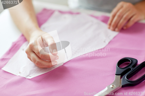 Image of woman with pattern and chalk drawing on fabric