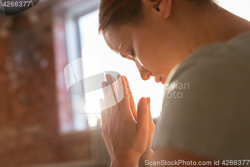 Image of close up of woman meditating at yoga studio