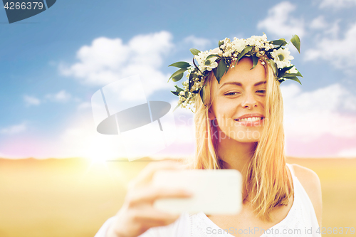 Image of happy young woman taking selfie by smartphone