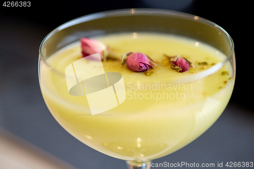 Image of close up of glass with creamy cocktail at bar