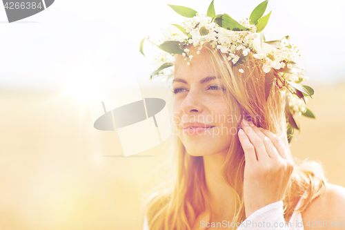 Image of happy woman in wreath of flowers