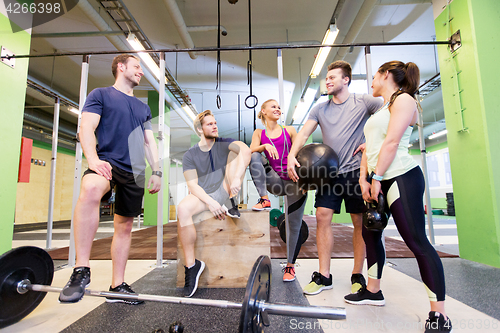 Image of group of friends with sports equipment in gym