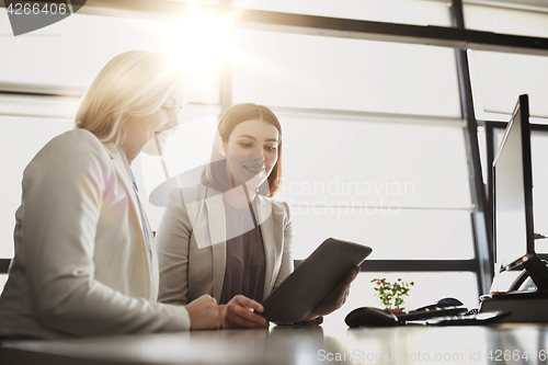Image of businesswomen with tablet pc computer at office