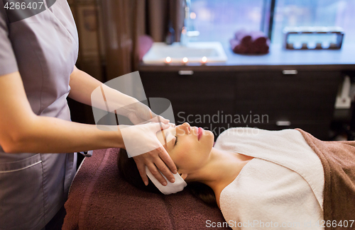 Image of woman having face and head massage at spa parlor