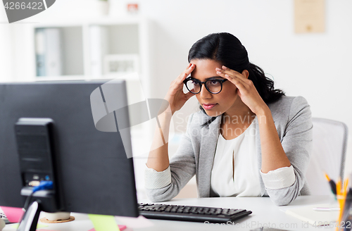 Image of stressed businesswoman with computer at office