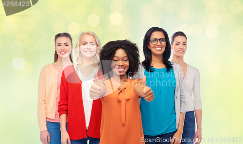 Image of international group of women showing thumbs up