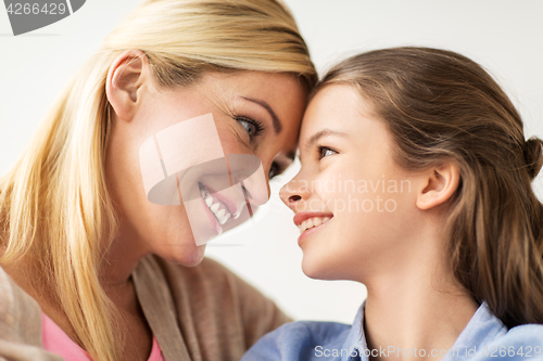 Image of happy smiling family of girl and mother at home