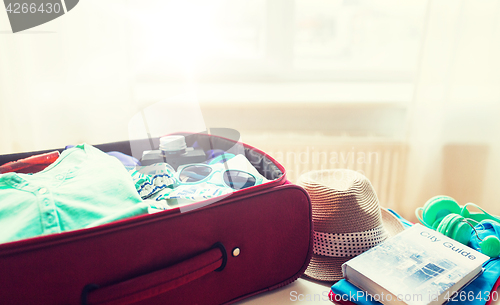 Image of close up of travel bag with clothes and stuff