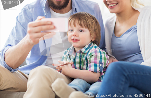 Image of happy family with smartphone at home