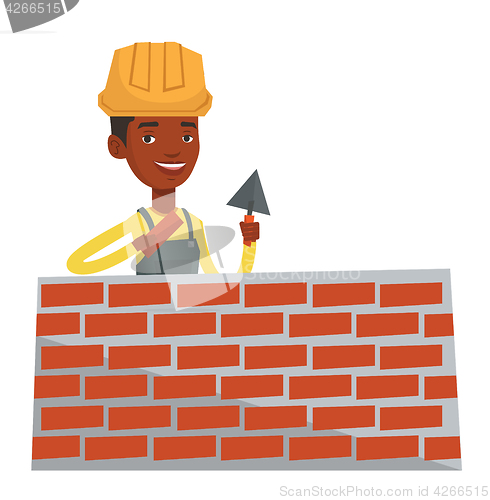 Image of Bricklayer working with spatula and brick.