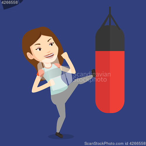 Image of Woman exercising with punching bag.