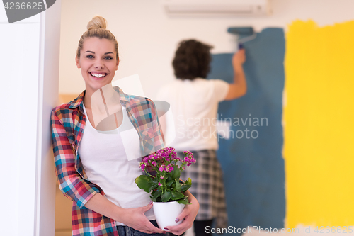 Image of happy young couple doing home renovations