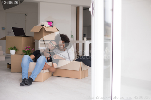 Image of African American couple  playing with packing material