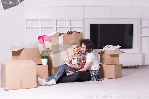 Image of young couple moving  in new house