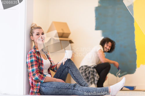 Image of young couple doing home renovations