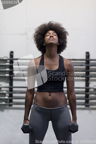 Image of black woman doing bicep curls