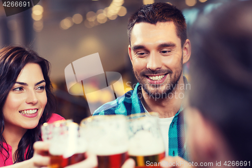 Image of friends dining and drinking beer at restaurant