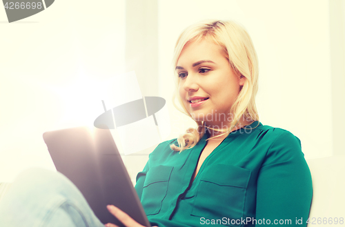 Image of smiling woman with tablet pc at home