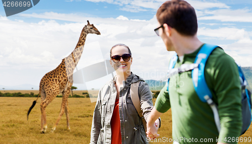 Image of smiling couple with backpacks traveling in africa