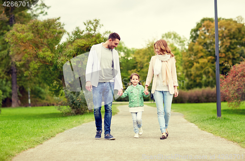 Image of happy family walking in summer park