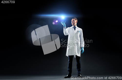 Image of doctor or scientist in lab coat with laser light