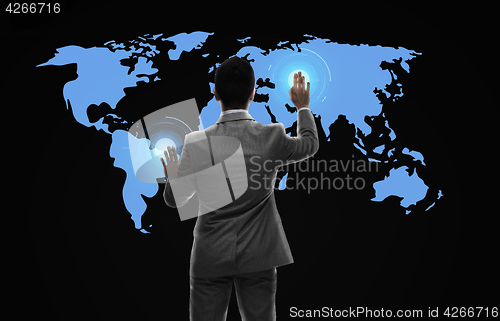 Image of businessman working with virtual world map