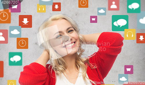 Image of happy smiling young woman in red cardigan