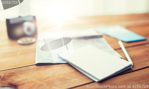 Image of close up of notepad with map and travel tickets