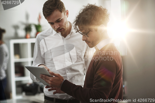 Image of close up of business team with tablet pc at office