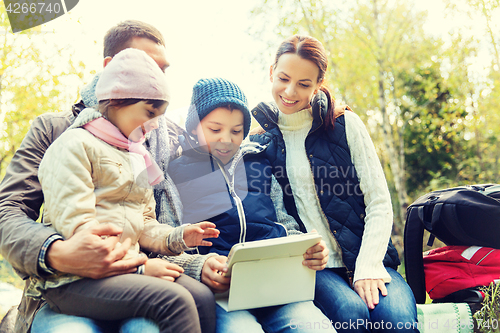 Image of happy family with tablet pc and backpacks at camp