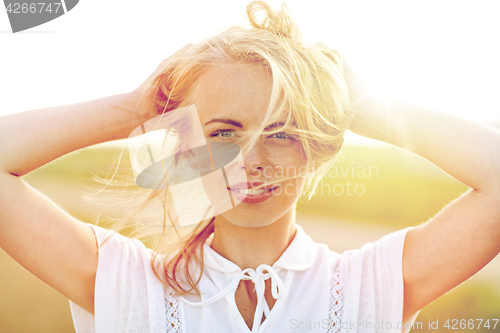 Image of close up of happy young woman in white outdoors