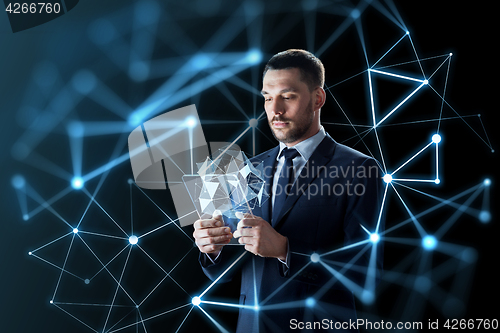Image of businessman working with transparent tablet pc