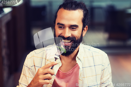 Image of happy man having dinner at restaurant