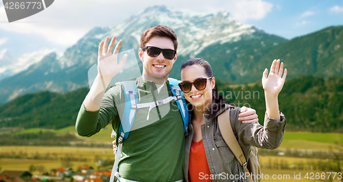 Image of happy couple with backpacks traveling in highlands