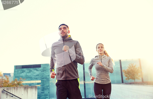 Image of happy couple running upstairs on city stairs