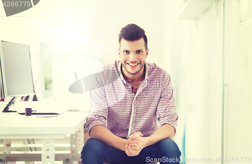 Image of happy creative man with computer at office