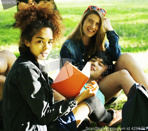 Image of cute group of teenages at the building of university with books huggings