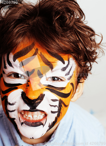 Image of little cute boy with faceart on birthday party close up, little cute tiger